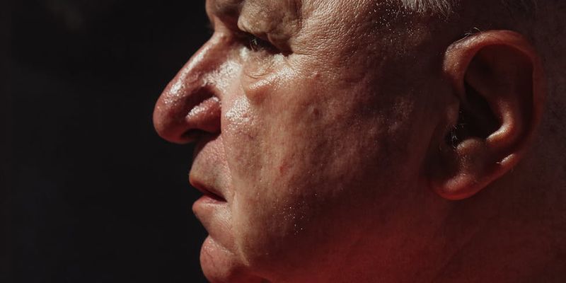 Side profile of a person breathing deeply after a workout.